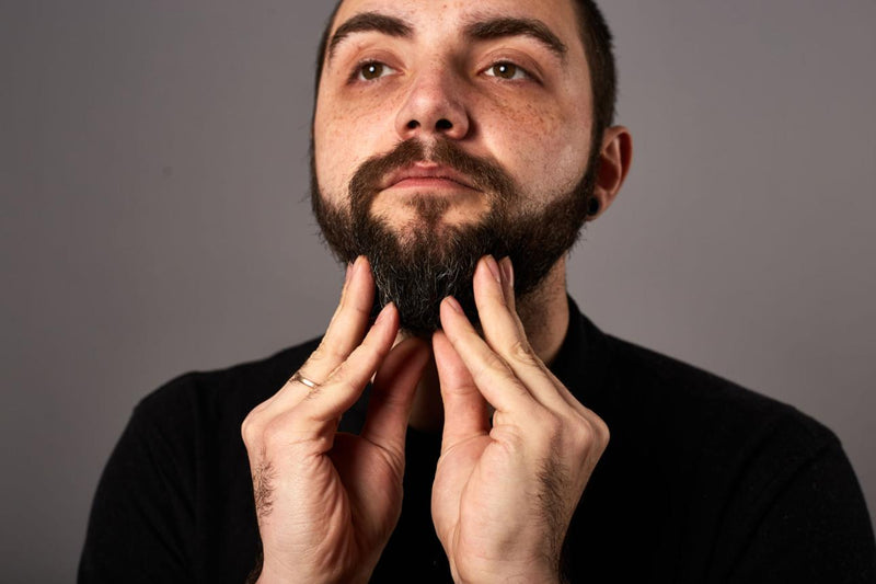 Man washing beard in shower